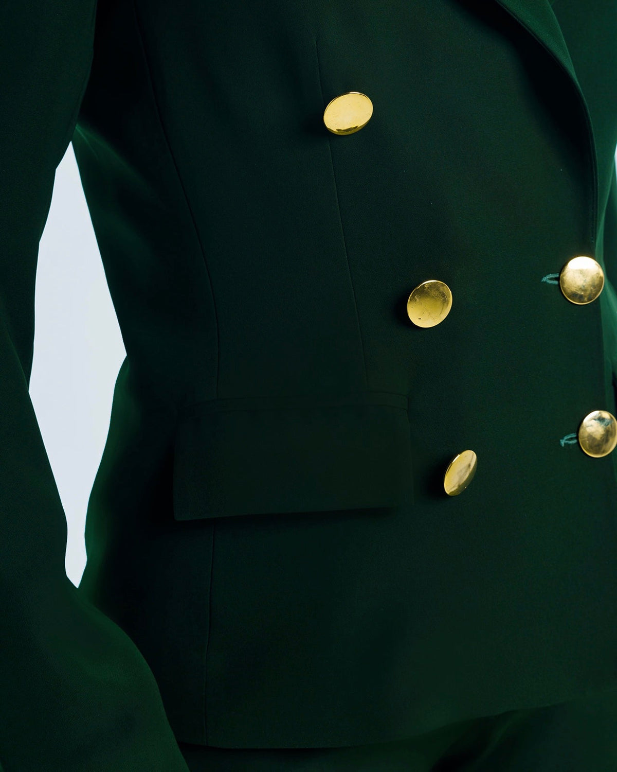 Dark green women's blazer with gold statement buttons, tailored fit, fashion detail