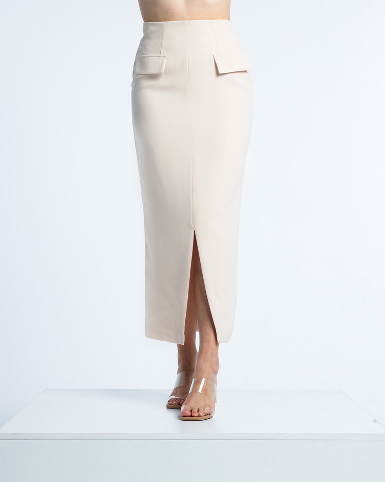 Woman wearing high-waisted beige midi pencil skirt with front slit and flap pockets