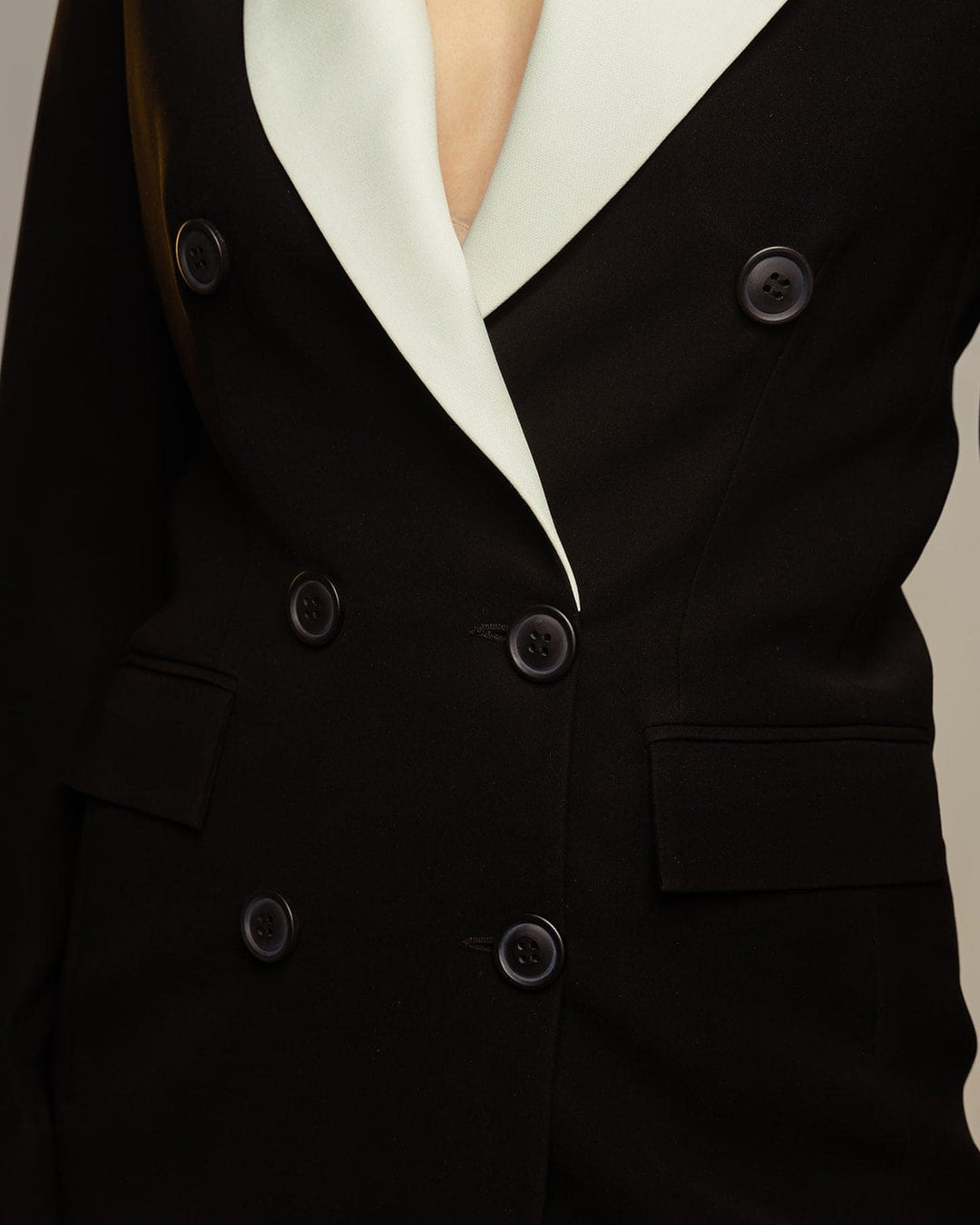 Close-up of double-breasted black suit jacket with contrasting light lapel