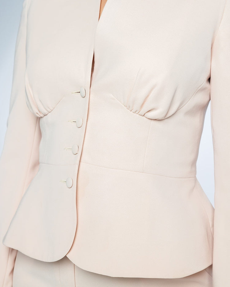 Elegant beige tailored women's blazer with structured seams and button details
