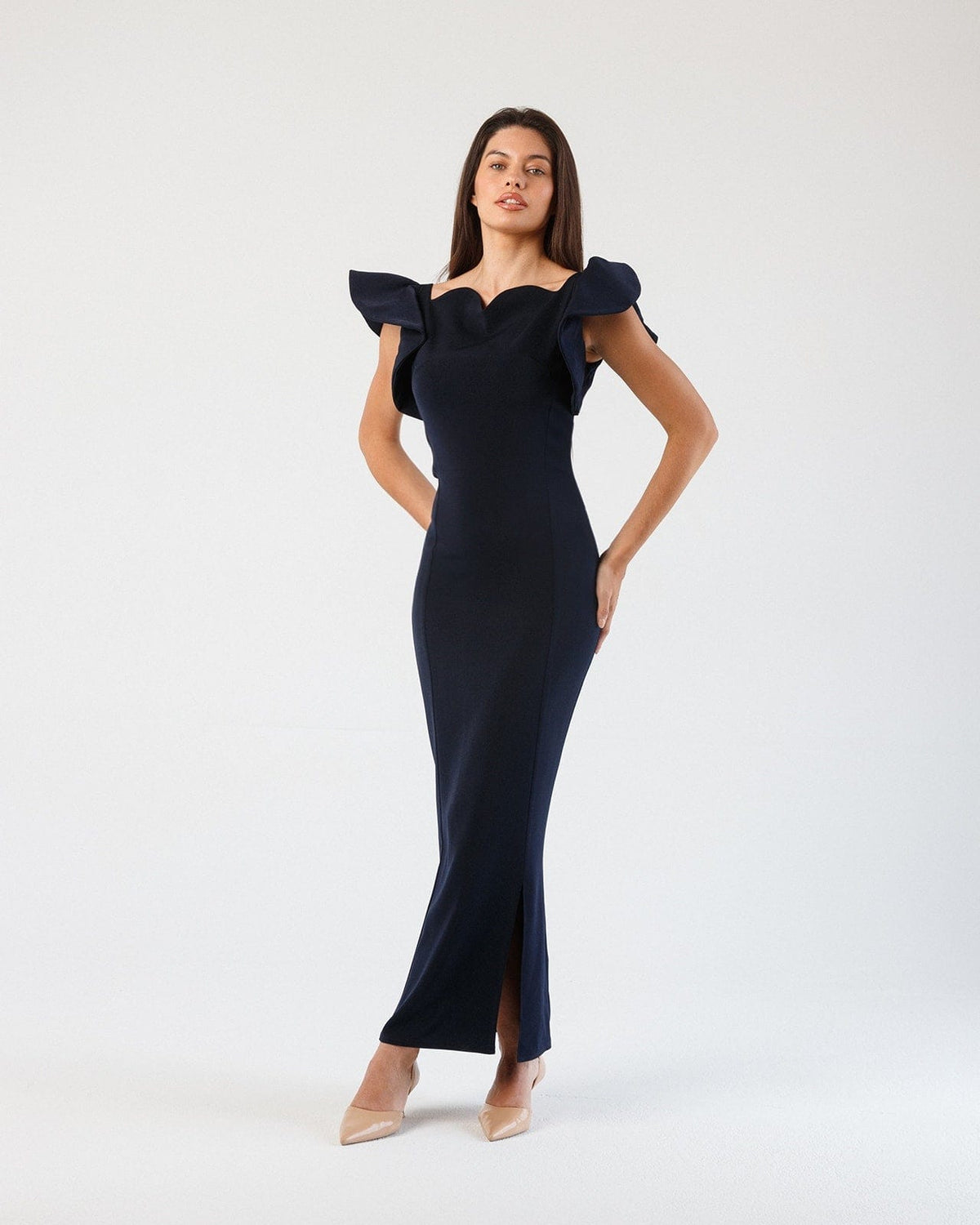 Woman in elegant dark blue evening gown with ruffled sleeves and side slit