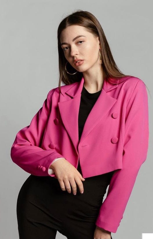 Woman modeling a fuchsia cropped blazer with double-breasted buttons and black outfit