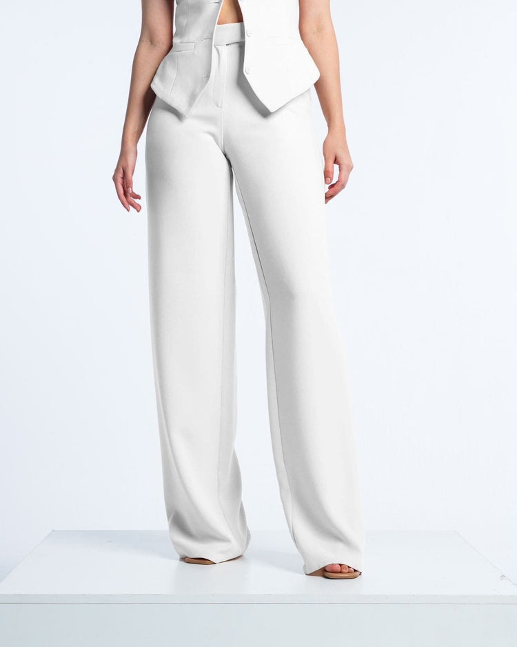 Woman wearing white tailored wide-leg trousers and matching sleeveless vest, elegant style