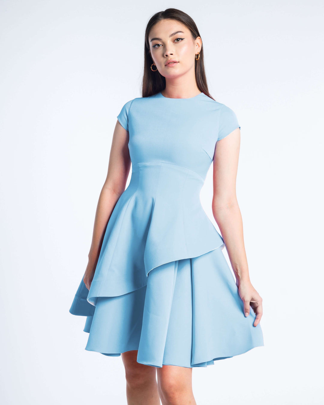 Woman wearing a short-sleeve layered baby blue dress with asymmetric skirt