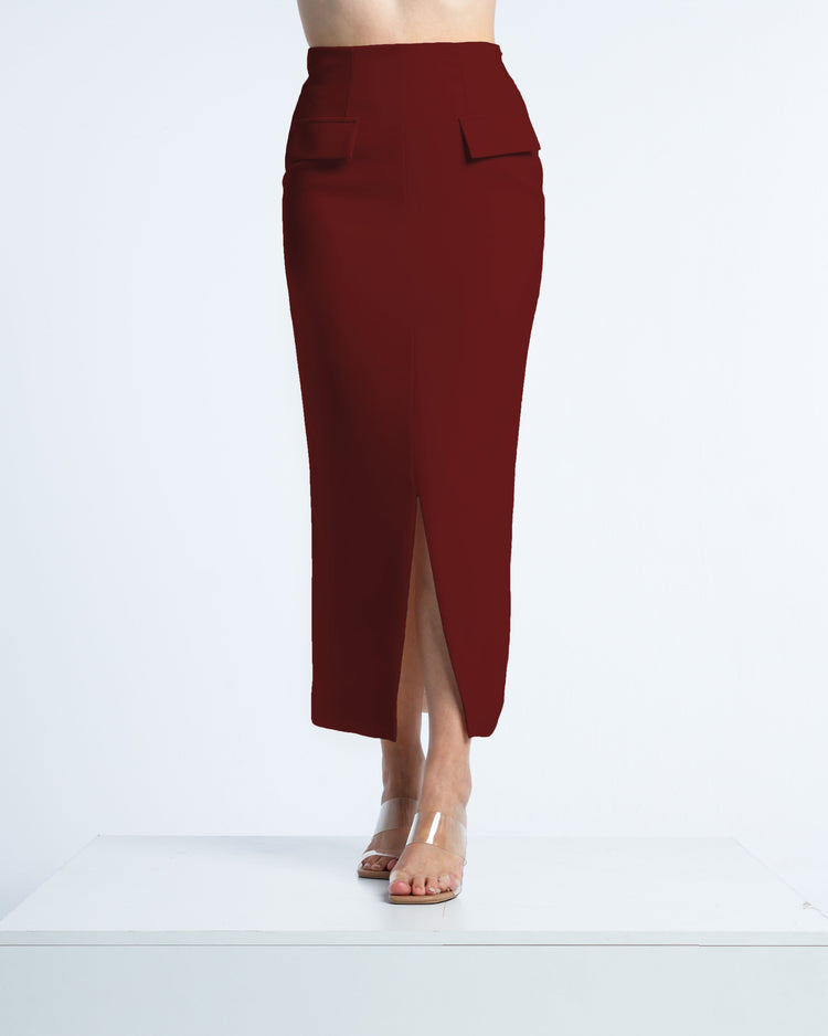 Woman wearing high-waisted maroon midi pencil skirt with front slit and clear sandals