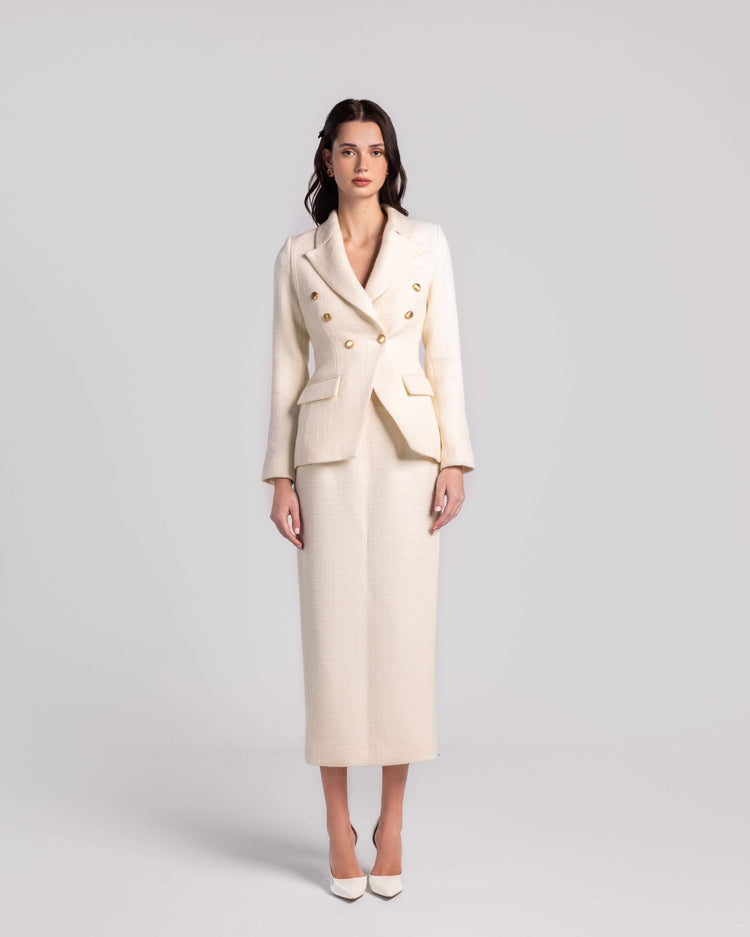 Woman wearing elegant cream double-breasted blazer and matching midi skirt set