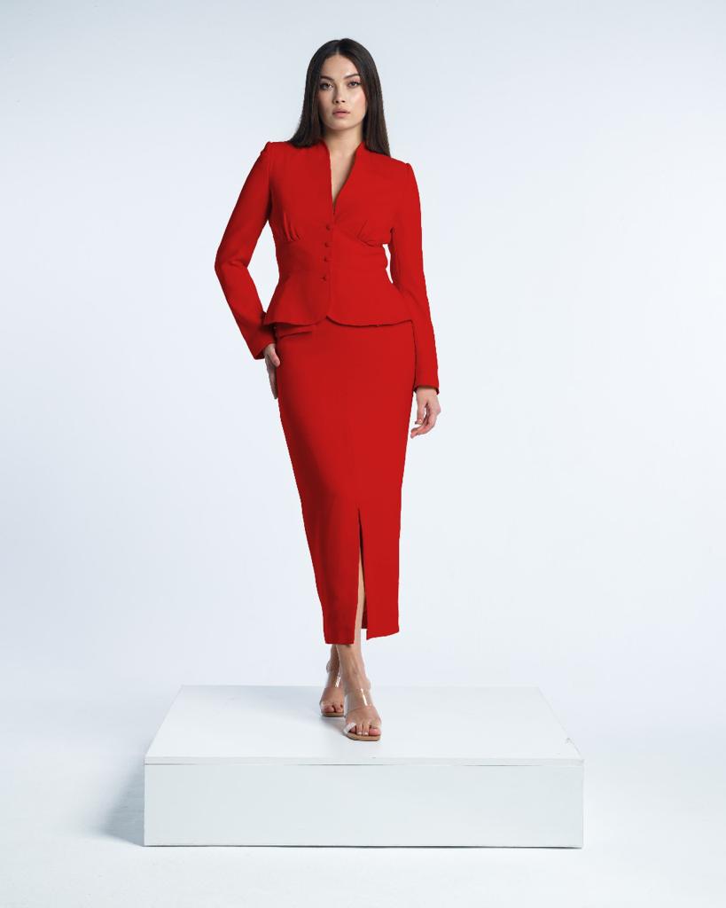Woman modeling elegant red skirt suit set with long sleeves and slit midi skirt on white background